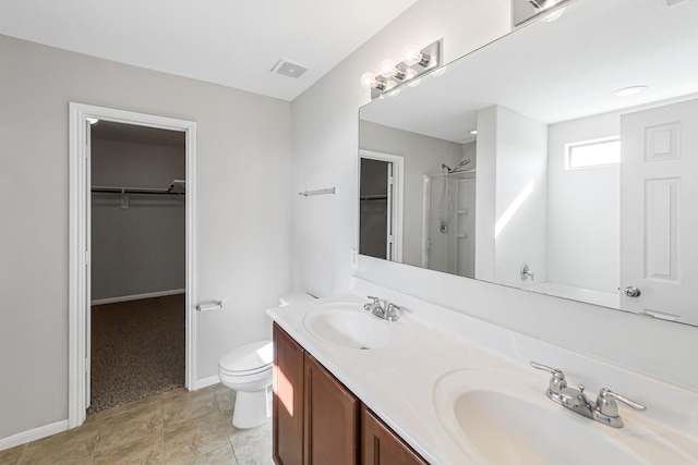 bathroom with vanity, toilet, and a shower