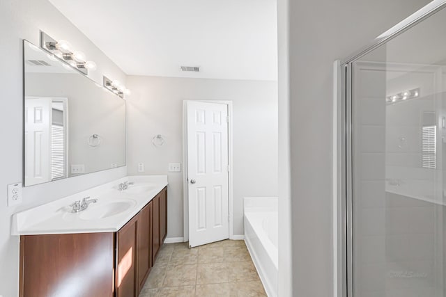 bathroom with tile patterned floors, vanity, and independent shower and bath