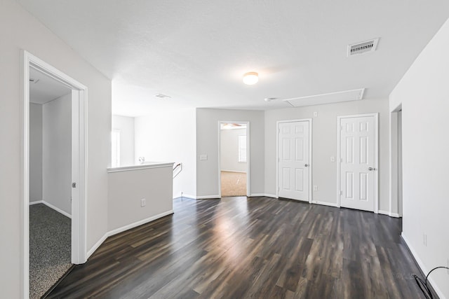 unfurnished room with dark hardwood / wood-style flooring