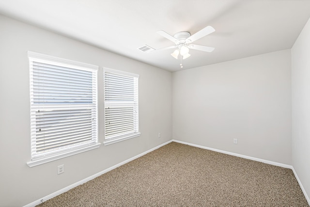 spare room with ceiling fan and carpet