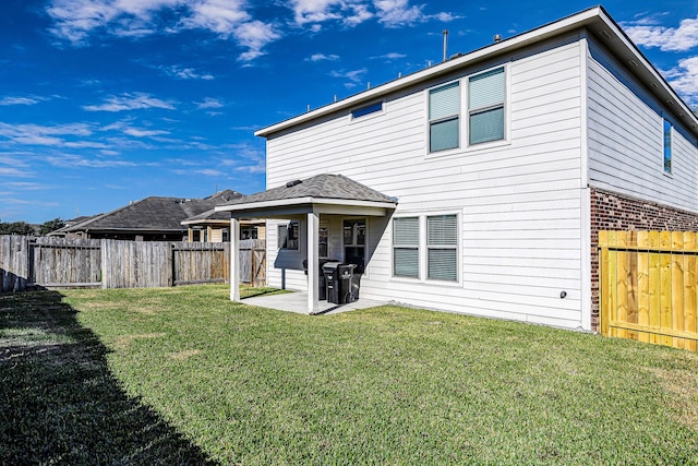 rear view of property featuring a patio area and a yard