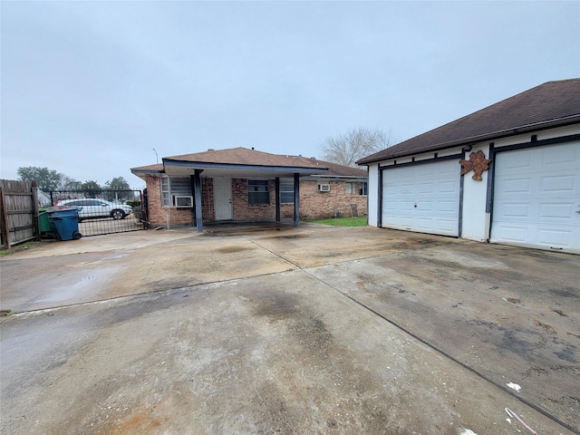 ranch-style home with a garage and cooling unit