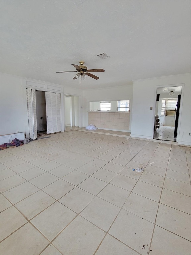 unfurnished living room with light tile patterned flooring and ceiling fan