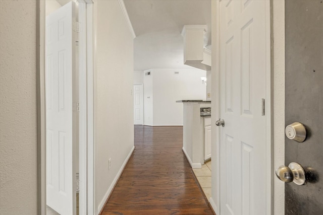 corridor with dark hardwood / wood-style flooring and crown molding