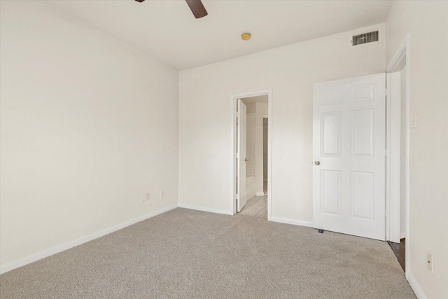 carpeted empty room with ceiling fan