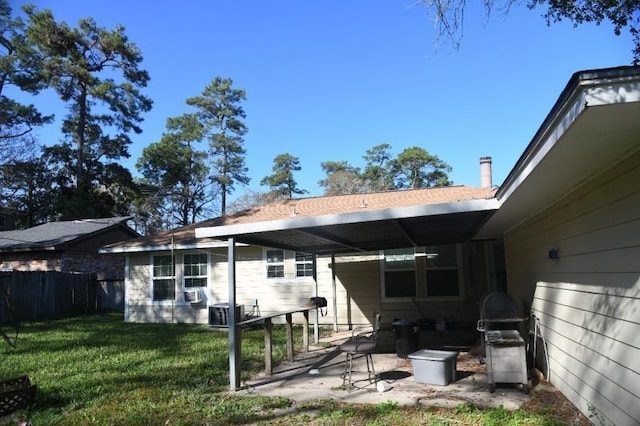 rear view of property with a yard and a patio