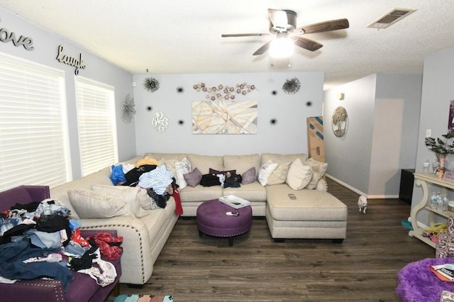 living room with ceiling fan and dark wood-type flooring