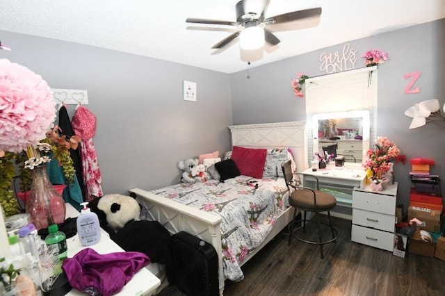 bedroom with ceiling fan and dark wood-type flooring