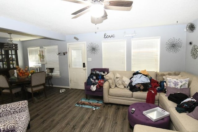 living room with ceiling fan and dark wood-type flooring