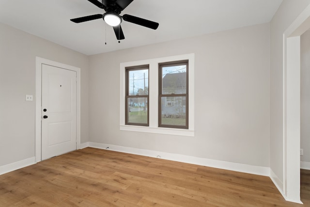 spare room featuring light hardwood / wood-style flooring and ceiling fan