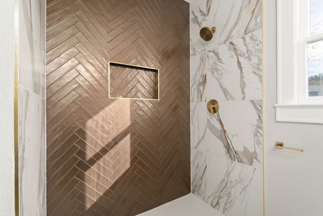 bathroom with a tile shower