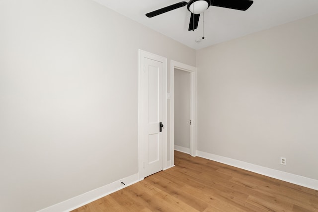 empty room featuring ceiling fan and light hardwood / wood-style flooring