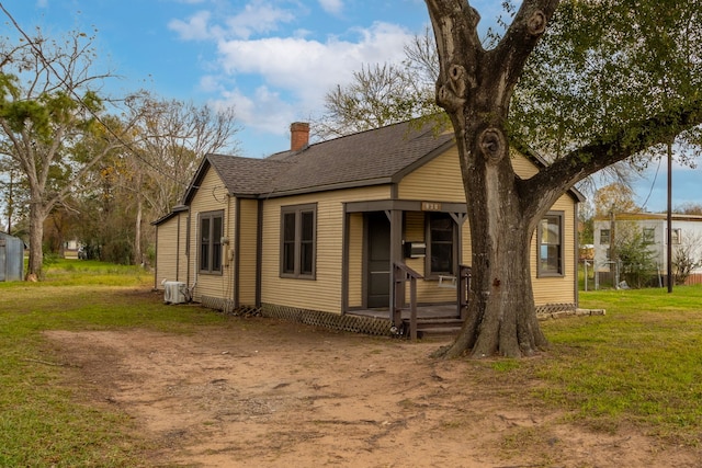 view of front of property with covered porch and a front yard