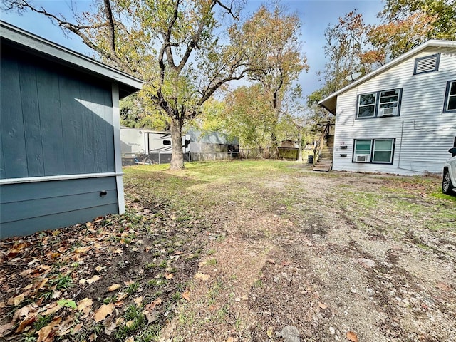 view of yard featuring stairway and fence