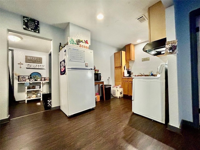 kitchen with dark hardwood / wood-style flooring, white appliances, exhaust hood, and washer / clothes dryer