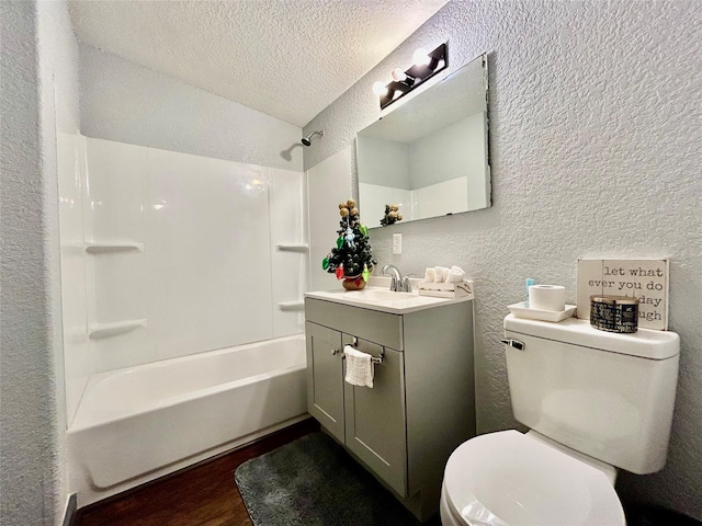 full bathroom with a textured wall, washtub / shower combination, a textured ceiling, vanity, and wood finished floors