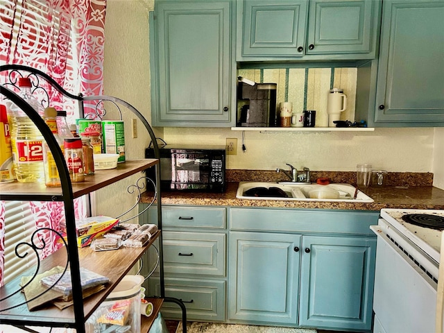 kitchen with dark countertops, white range with electric cooktop, green cabinetry, and a sink