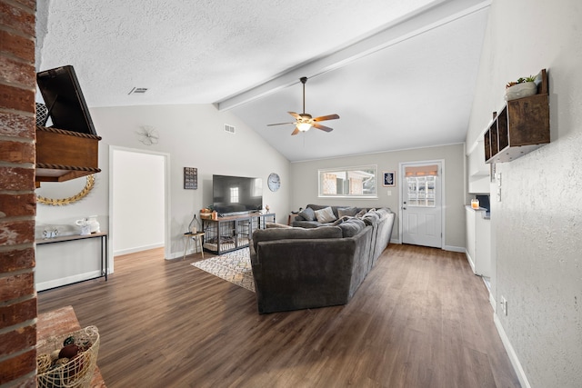 living room with ceiling fan, dark hardwood / wood-style floors, lofted ceiling with beams, and a textured ceiling