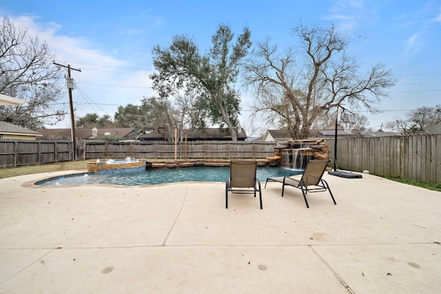 view of pool featuring pool water feature, an in ground hot tub, and a patio