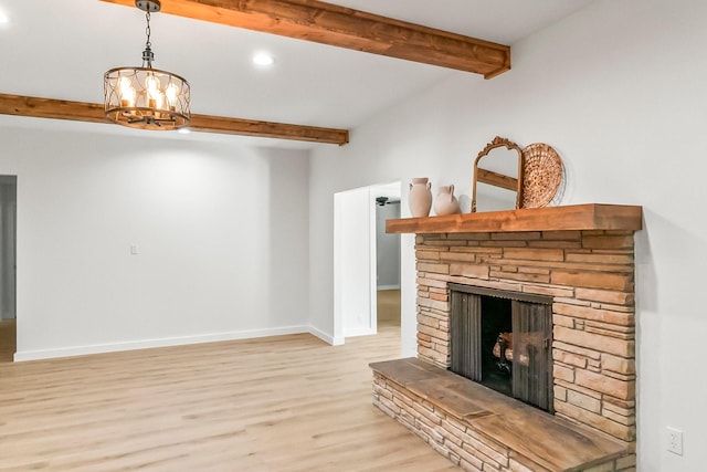 living room featuring light hardwood / wood-style flooring, a stone fireplace, an inviting chandelier, and beamed ceiling