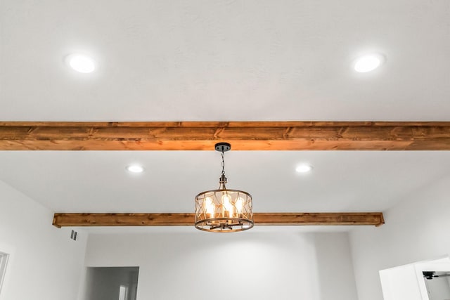 room details with an inviting chandelier and beamed ceiling