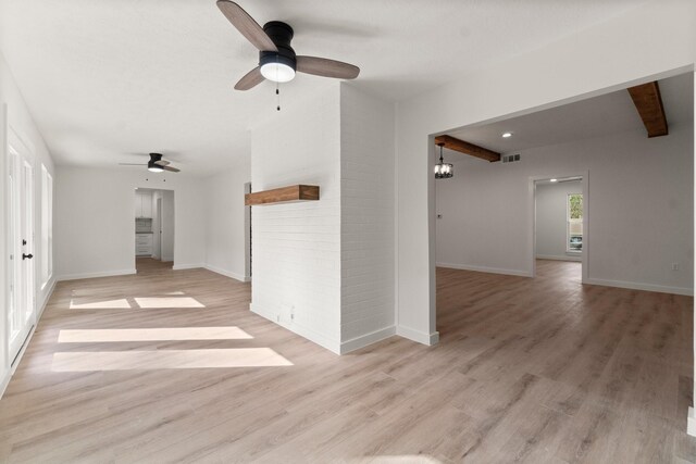 unfurnished living room featuring ceiling fan, light hardwood / wood-style flooring, and beam ceiling