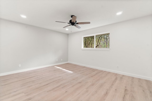 spare room with ceiling fan and light hardwood / wood-style flooring