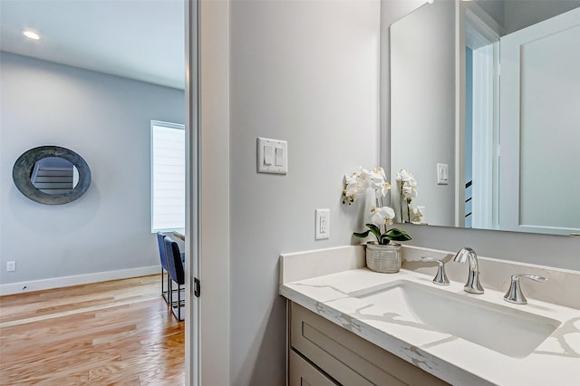 bathroom with vanity and hardwood / wood-style flooring