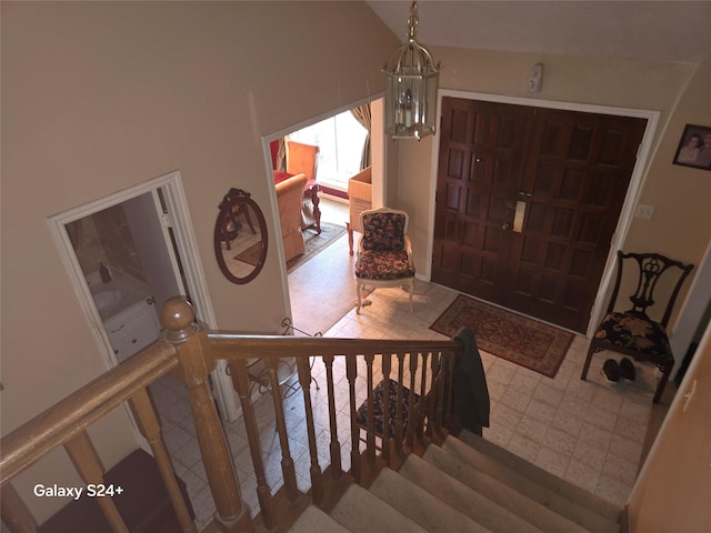 entrance foyer featuring vaulted ceiling and an inviting chandelier