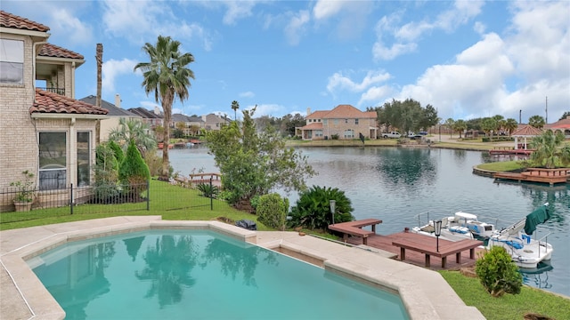 view of pool featuring a water view and a lawn