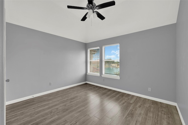 unfurnished room featuring lofted ceiling, ceiling fan, and dark wood-type flooring