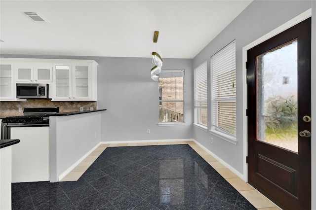 unfurnished dining area with light tile patterned floors