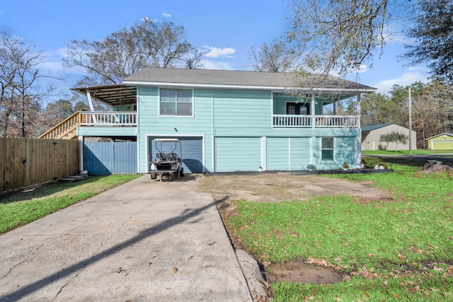 rear view of property with a yard and a garage