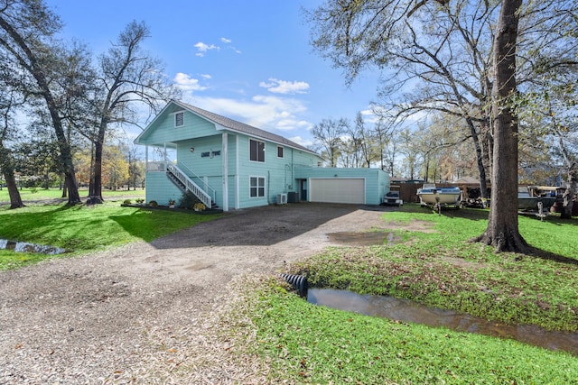 view of property exterior with a yard and a garage