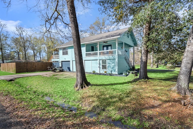 exterior space with a front yard, a garage, and ceiling fan