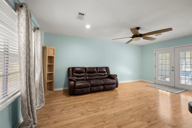 living room with french doors, light hardwood / wood-style floors, and ceiling fan