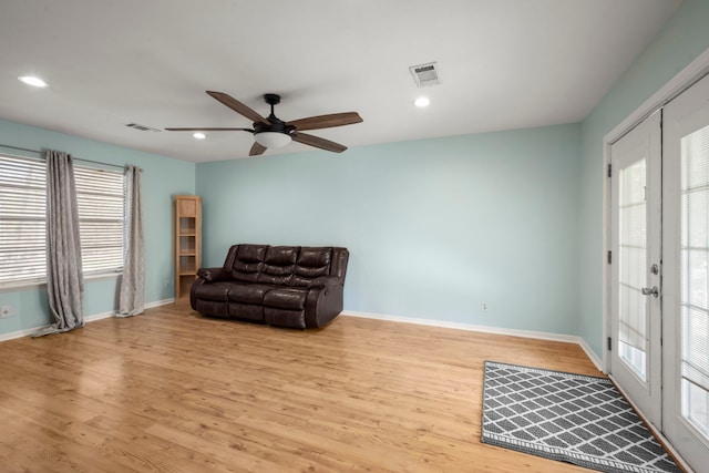 living area featuring ceiling fan, light hardwood / wood-style flooring, and french doors