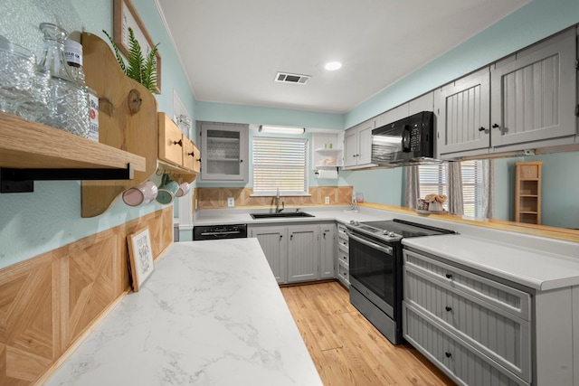 kitchen featuring kitchen peninsula, sink, gray cabinetry, and black appliances