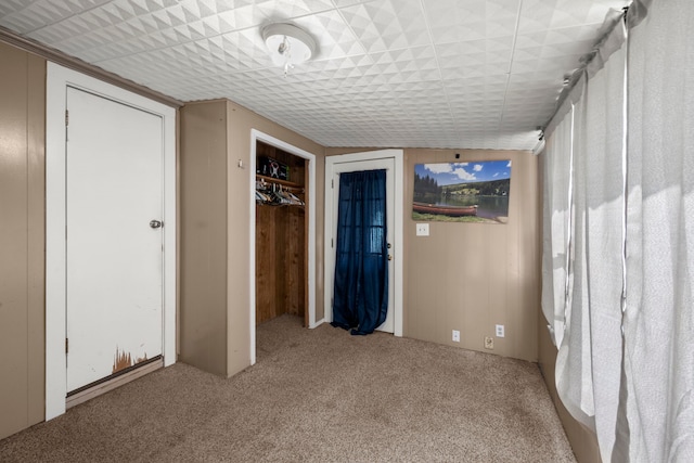 unfurnished bedroom featuring light colored carpet and a closet