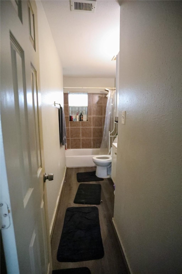 full bathroom featuring vanity, hardwood / wood-style floors, shower / bathtub combination with curtain, and toilet