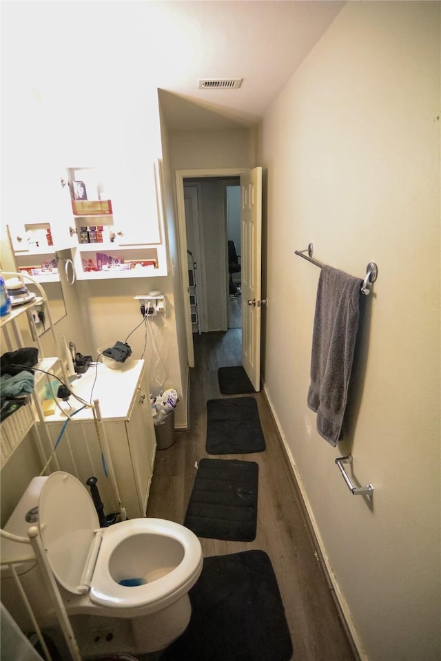 bathroom featuring toilet and hardwood / wood-style flooring