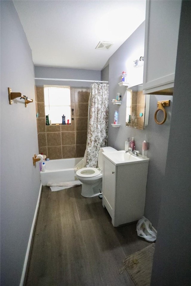 full bathroom with vanity, wood-type flooring, shower / tub combo, and toilet