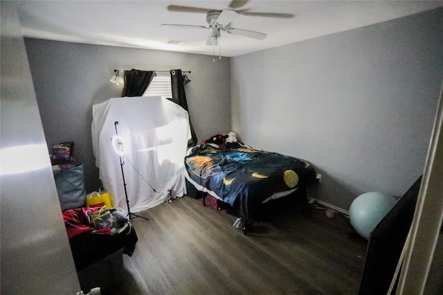 bedroom with hardwood / wood-style floors and ceiling fan