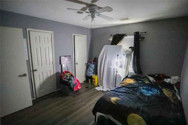 bedroom with ceiling fan and dark wood-type flooring