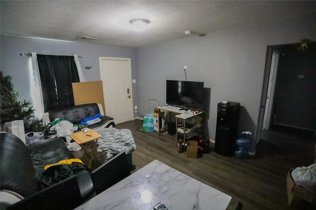 living room with dark hardwood / wood-style flooring and a textured ceiling