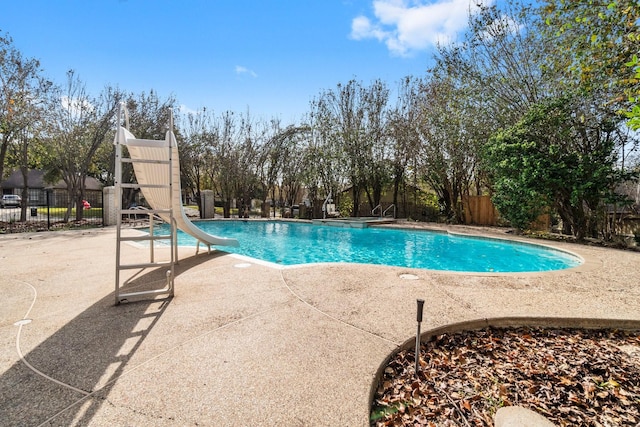 view of pool featuring a patio and a water slide