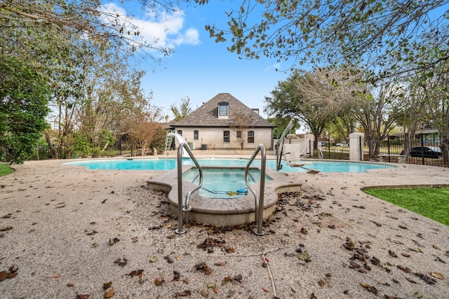 view of pool with a patio area and an in ground hot tub