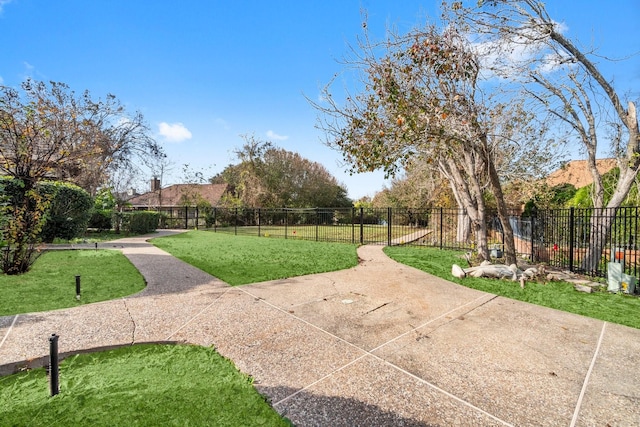 view of home's community featuring a lawn and a patio area