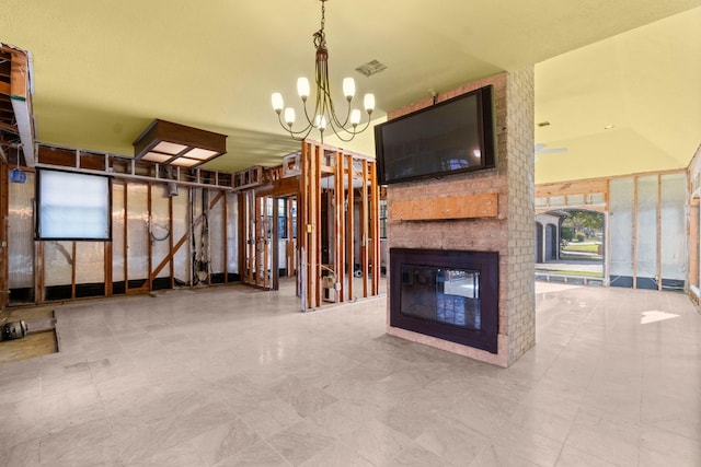 interior space featuring a fireplace and a chandelier