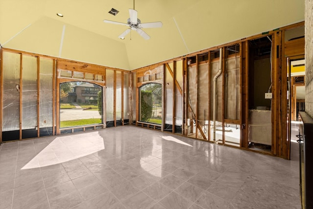 interior space with ceiling fan and a towering ceiling